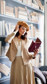 The lady with the beret wears a pleated skirt.